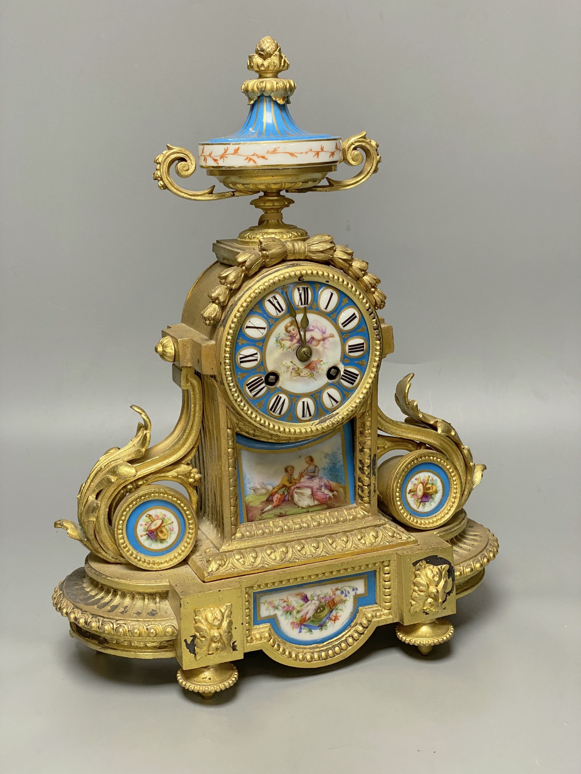 A Louis XVI ormolu mantel clock inset Sevres style panels, height 38cm